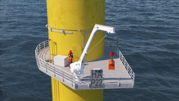 A rendered image of PALFINGER MARINE's fixed boom crane on a wind turbine platform which is operated by an engineer standing next to the crane.